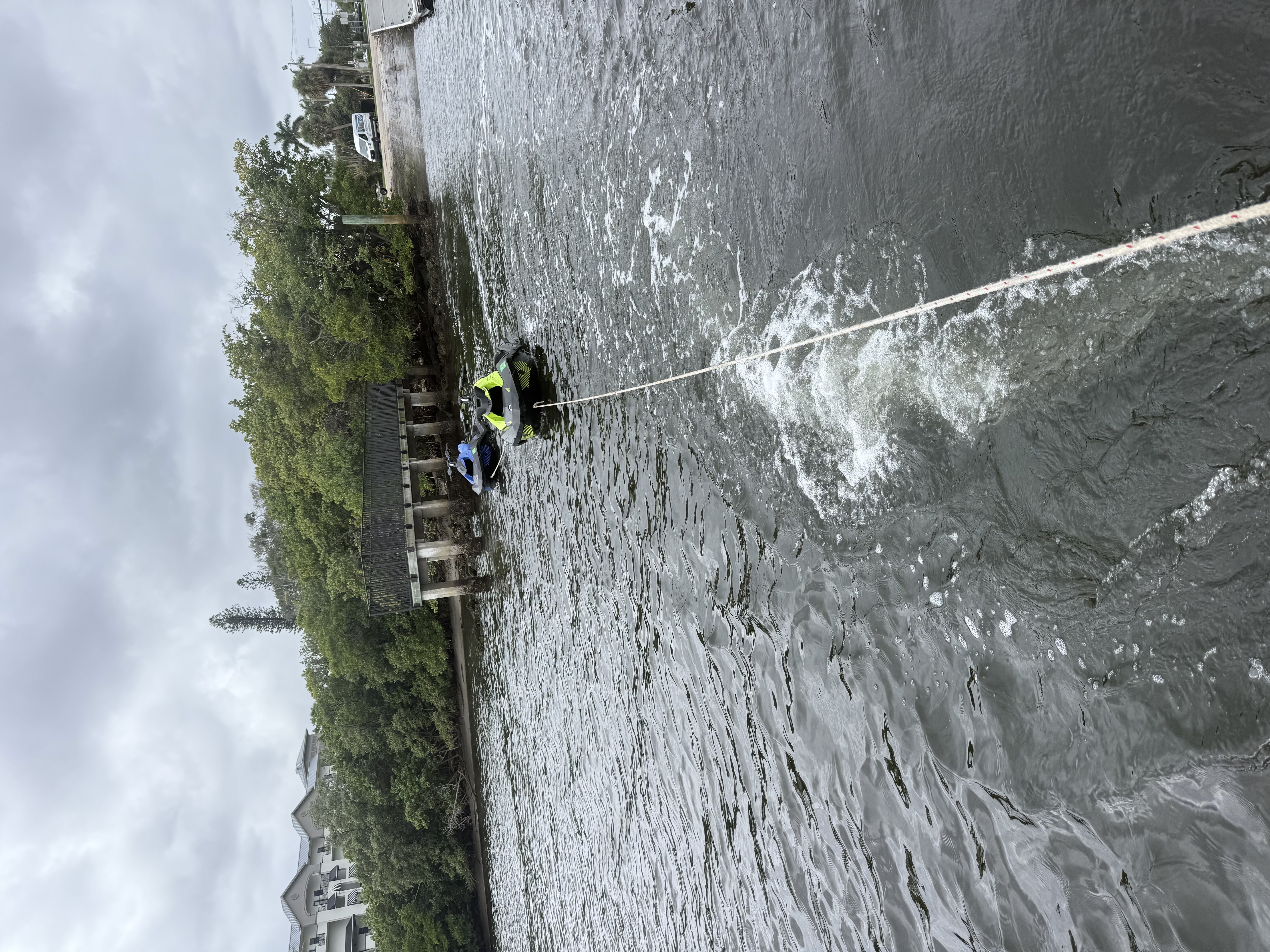 Towing two disabled skis back to the ramp